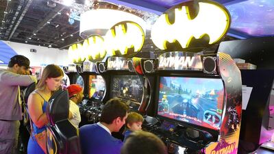 Vistors play a Batman arcade game. Pawan Singh / The National