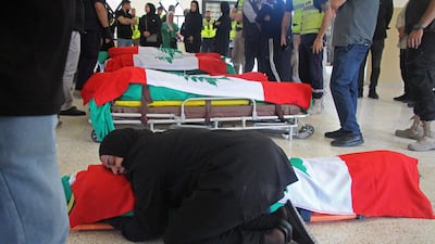 A mourner weeps next to the body of a victim killed in an Israeli strike in Tyre, southern Lebanon last month. AFP