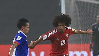 Omar Abdulrahman fights for the ball with Malaysia’s Mohamad Nasir. Ravindranath K / The National