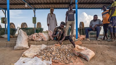 Workers crush ore containing gold at a small-scale milling operation outside Atbara, Sudan. Bloomberg