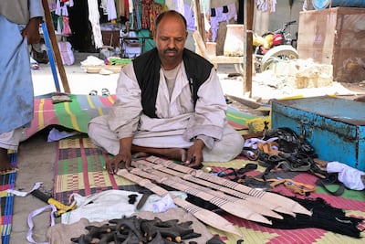 A Sudanese man from the Beja ethnic group of eastern Sudan makes sheaths for the traditional straight double-edged kaskara swords in Port Sudan. AFP
