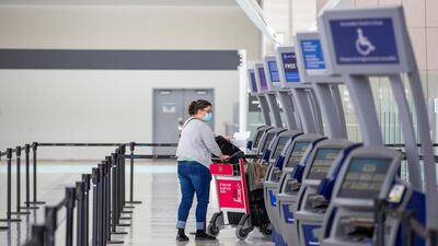 A passenger walks through terminal 1 at Toronto's Pearson Airport after mandatory Covid-19 testing took effect for international arrivals in Mississauga, Ontario, Canada. Reuters