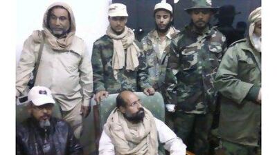 A reader argues that the Qaddafis, including Saif Al Islam, centre, deserve a fair trial. Reuters