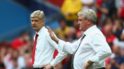 Arsenal manager Arsene Wenger and Hull City manager Steve Bruce shown during their sides' contest on Saturday. Paul Gilham / Getty Images / May 17, 2014
