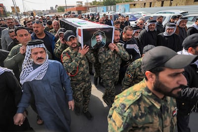 Mourners march while carrying the coffin of a member of Iraq's pro-Iran militias. AFP