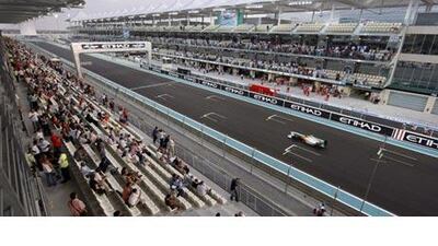 Formula One fans watch the second practice round action from the main grandstand of the Yas Marina Circuit.