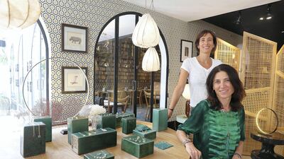 DUBAI , UNITED ARAB EMIRATES , SEP 19 – 2017 : - Emma Sawko , founder ( left in white ) and Mathilde Danglade , jewellery designer ( right in green ) with the new collection of jewellery which is on display at the Comptoir 102 on Jumeirah Beach Road in Dubai. ( Pawan Singh / The National ) Story by Hafsa Lodi