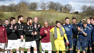 Roberto Carlos takes photos with Bull in the Barne United and Harlescott Rangers players. AFP