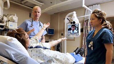 A telepresence robot connects a patient with expert neurologists. The technology is also being used in education and retailing. Larry Laszlo / PRNewsFoto