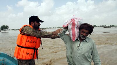 A man is given food by the Pakistan Army during relief operations in the Rajanpur district of Punjab. AP
