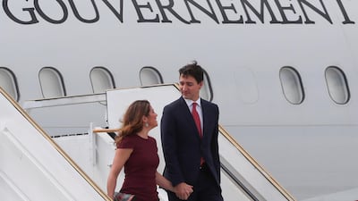 Canada's Prime Minister Justin Trudeau and wife Sophie Gregoire Trudeau chat as they leave their aeroplane. Reuters