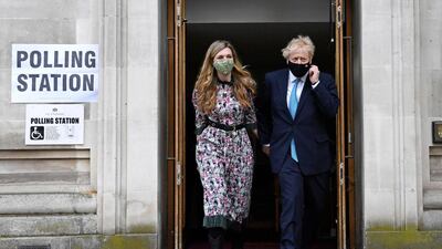 Prime Minister Boris Johnson, right, and his fiancee Carrie Symonds leave after casting their vote at Methodist Central Hall, central London, Thursday May 6, 2021. AP