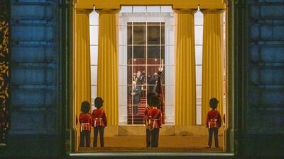 King Charles III watches from a window as the hearse carrying the coffin of Queen Elizabeth arrives at Buckingham Palace. AP