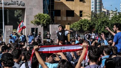 Lebanese students from various schools shout slogans and burn history books during ongoing anti-government protests in front the Education Ministry in Beirut, Lebanon 21 November 2019. EPA/NABIL MOUNZER