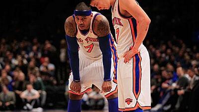 Carmelo Anthony, left, and Jeremy Lin of the New York Knicks stand on the court against the New Jersey Nets at Madison Square Garden.
