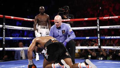Referee Celestino Ruiz checks on Shawn Porter after he was knocked down by WBO champion Terence Crawford in the 10th round. AFP