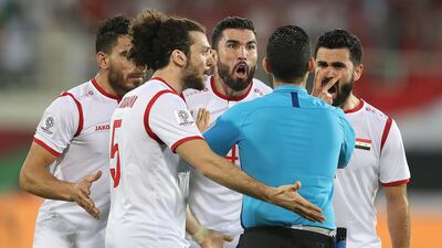 Syria players protests to referee Cesar Ramos of Mexico following Australia's second goal. Getty Images