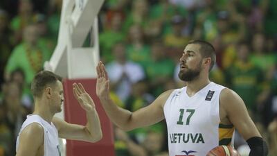 Lithuania's Jonas Valanciunas, right, of the Toronto Raptors high fives teammate Renaldas Seibutis at EuroBasket 2015 on Sunday. Valda Kalnina / EPA