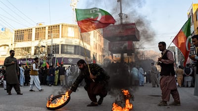 Activists of the Pakistan Tehreek-e-Insaf party burn tyres in Quetta, during a protest against the decision to disqualify former prime minister Imran Khan from holding office. AFP