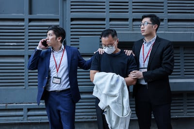 Independent Commission Against Corruption (ICAC) officers escort a suspect to the offices of Will Power Architects Company for a search in connection with potential corruption during the renovation project at Wang Fuk Court housing estate, in Hong Kong. Reuters