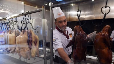 A chef at Beijing's Quanjude restaurant prepares Peking duck. The restaurant, the flagship of a chain with franchises as far afield as Australia, marked its 150th anniversary by opening a museum dedicated to its history of the famous Peking duck dish. Greg Baker / AFP