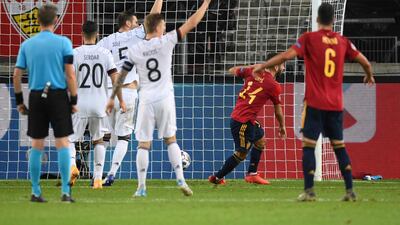 Germany players raise their arms after Jose Gaya scores Spain's equaliser. Getty Images