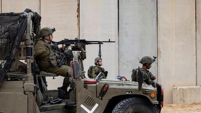 Israeli soldiers guard the site of a ceremony marking the completion of an enhanced security barrier along the Israel-Gaza border, on December 7, 2021. All photos: AP