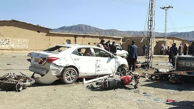 Security personnel inspect the site of a bomb blast outside the office of an independent candidate in Pishin district, on the eve of Pakistan's national elections. AFP