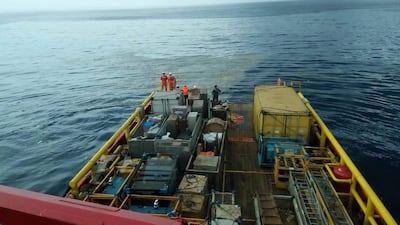 Rescuers inspect oil slick debris believed to be from the Lion Air jet. AP Photo