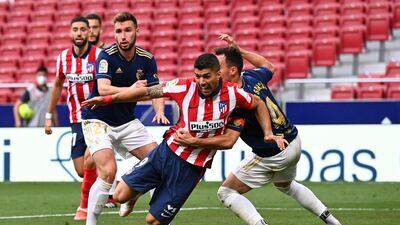 Luis Suarez is grabbed by Osasuna defender Unai Garcia. AFP
