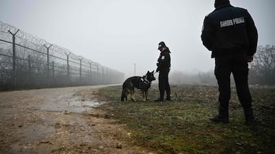 Bulgarian border police officers patrol a fence on the frontier with Turkey. AFP