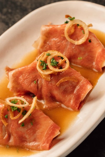 Steamed beef gyoza in ponzu butter topped with Wagyu and crispy onion. Photo: Yubi