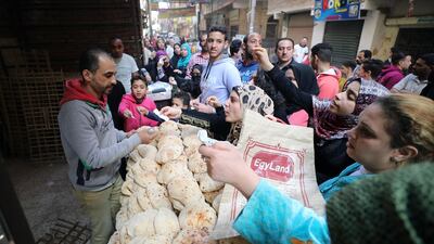 Egyptians buy bread from a bakery in Cairo, Egypt.