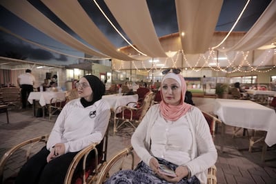 Diala Al-Madani and her mother Sherin Abu Shaaban watch the exercises at the Friends Equestrian Club. Courtesy Fady Hanona