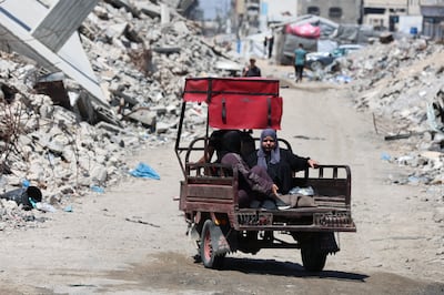Palestinians amid the rubble of residential buildings destroyed during the Israeli war, in Gaza city. Reuters