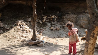 A child stands outside a cave where a Yemeni family has sought refuge due to poverty and lack of housing, west of the suburbs of Yemen's third-city of Taez on December 2. AFP