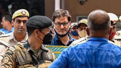 Police escort Yasin Malik (C) to a holding area after a sentencing hearing at Patiala house court in New Delhi on Wednesday. AFP