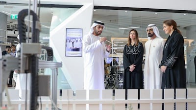 Sheikh Mohammed bin Rashid listens to a presentation with Tamkeen chairman Rima Al Mokarrab and food minister Mariam Al Mehairi. Courtesy: Dubai Media Office