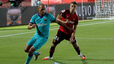 Barcelona's Martin Braithwaite, left, vies for the ball with Mallorca's Martin Valjent. AP Photo