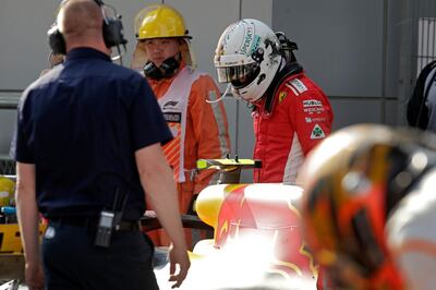 Ferrari driver Sebastian Vettel of Germany looks at the car of Red Bull driver Max Verstappen of the Netherlands after the Chinese Formula One Grand Prix at the Shanghai International Circuit. Vettel finished eighth. Andy Wong / AP Photo