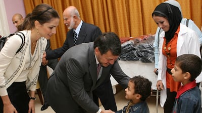 King Abdullah and Queen Rania wish children at an Amman orphanage a happy Ramadan in October 2006. AFP