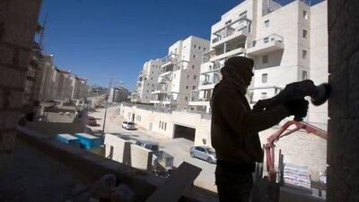 A Palestinian labourer works at a construction site in a Jewish settlement near Jerusalem known to Israelis as Har Homa and to Palestinians as Jabal Abu Ghneim.