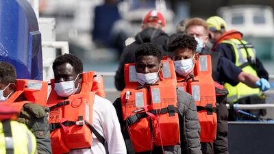 A group of people thought to be migrants are brought in to Dover, UK, on Tuesday after being found on a small boat in the Channel. PA