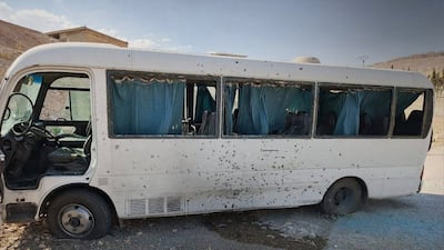 A handout picture released by the official Sana news agency shows a badly damaged bus at the side of a road following a blast in the countryside near the capital Damascus on August 22, 2026. Sana/AFP