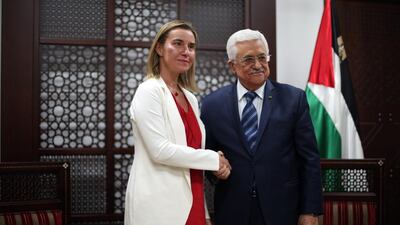 Palestinian president Mahmoud Abbas poses for a picture with the European Union's new foreign affairs chief Federica Mogherini in the West Bank town of Ramallah on November 8. Abbas Momani / AFP