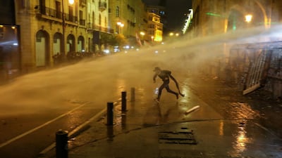 A demonstrator is hit by a water cannon during a protest against a ruling elite accused of steering Lebanon towards economic crisis in Beirut, Lebanon January 19, 2020. Reuters