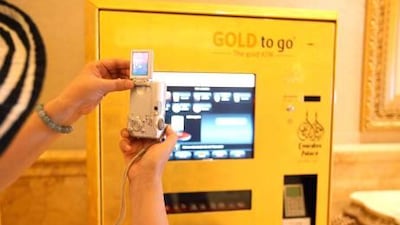 A year after its installation, hordes of buyers are still drawn to the gold dispensing machine at the Emirates Palace hotel, with a one-gram gold coin set to be introduced within weeks.