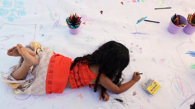 Lili, 5, happily kicked her heels in the sunshine while discovering her creative side during the Happiness Festival, which kicked off in Dubai on Friday, March 10, 2017. DELORES JOHNSON / The National