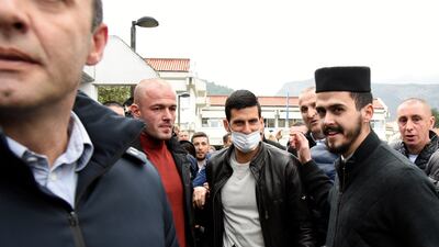 Novak Djokovic, center, arrives in a municipal building in Budva, Montenegro. AP