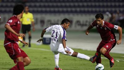 Al Ain's Fawzi Fayez reaches for the ball against Wahda's Tawfeeq Al Hosani. Pawan Singh / The National.